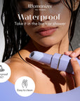 Lila Womanizer Beauty läppstiftsvibrator med skyddslock
