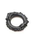 Creature Cocks Black Caiman Silicone Penisring liggandes mot vit bakgrund.
