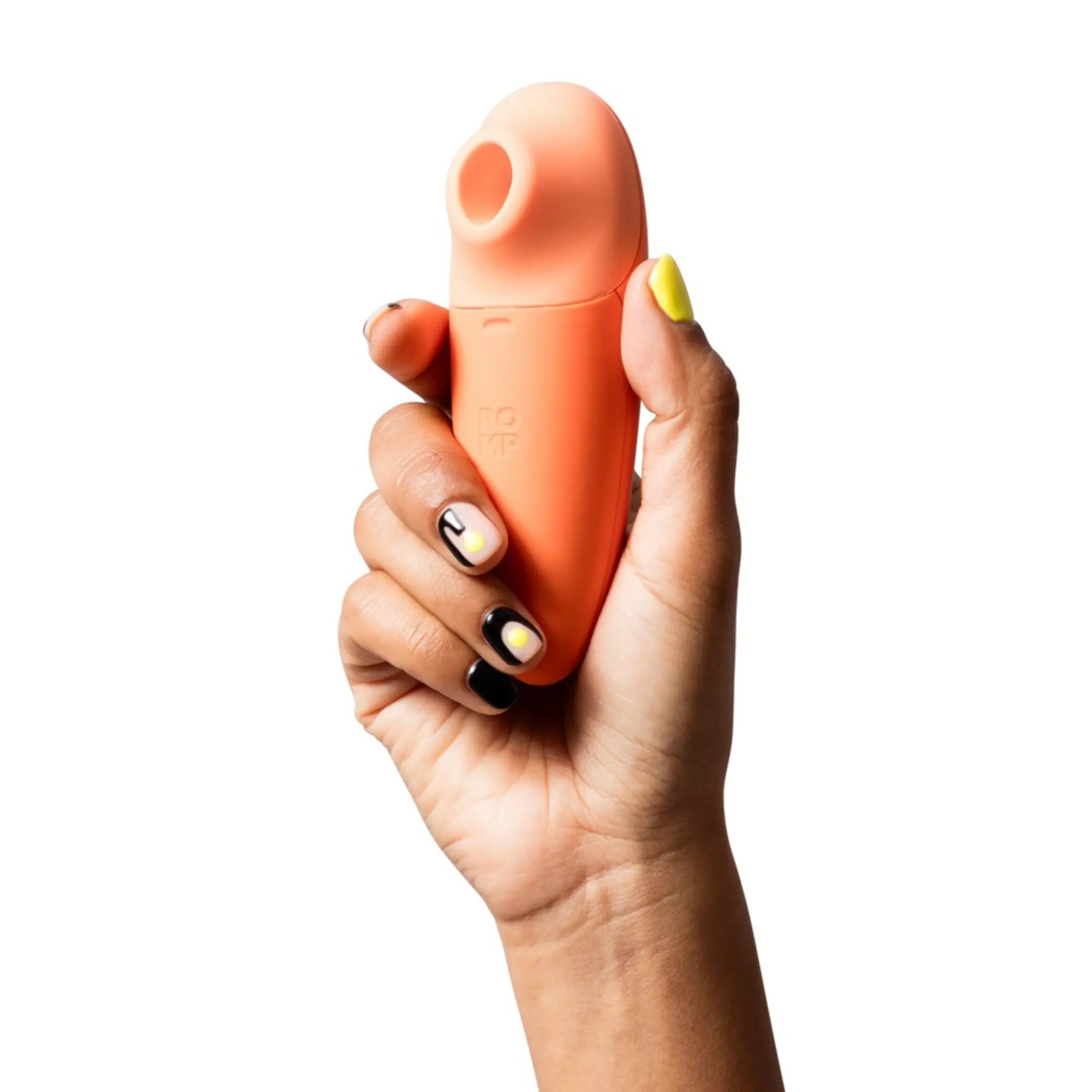 En hand håller i en Romp Switch X Lufttrycksvibrator
