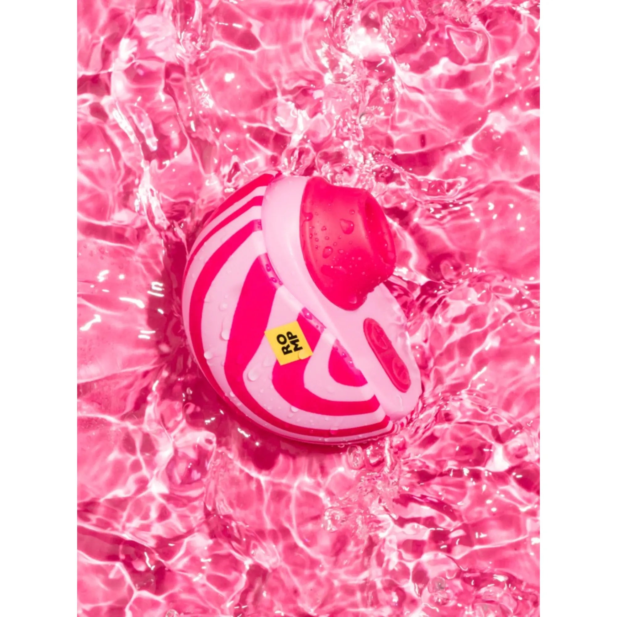 Moodbild på Romp Spin Lufttryckvibrator som ligger i rosa vatten
