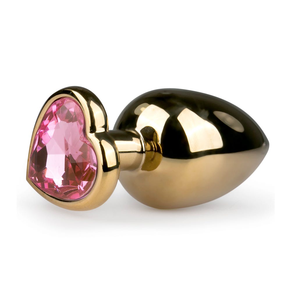 Metal Butt Plug No. 8 Gold/Pink liggandes mot vit bakgrund.