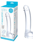 Gläs Realistic Curved G-Spot Dildo och produktförpackning mot vit bakgrund.