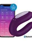 Satisfyer Double Joy Violet Appstyrd Parvibrator med en smartphone bakom som visar en app.