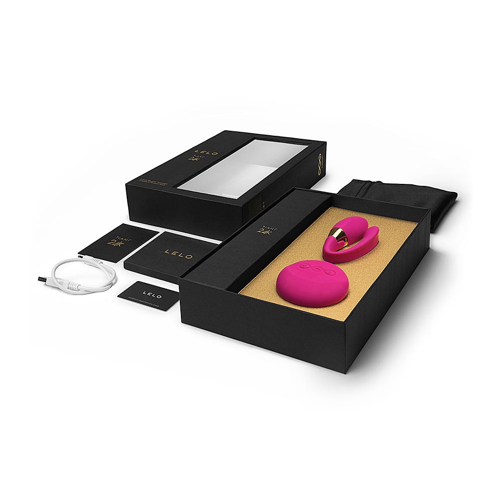 LELO Tiani 24k Cerise Samlagsvibrator i en rosa färg i en svart ask. På bilden syns även en manual samt en laddare. 