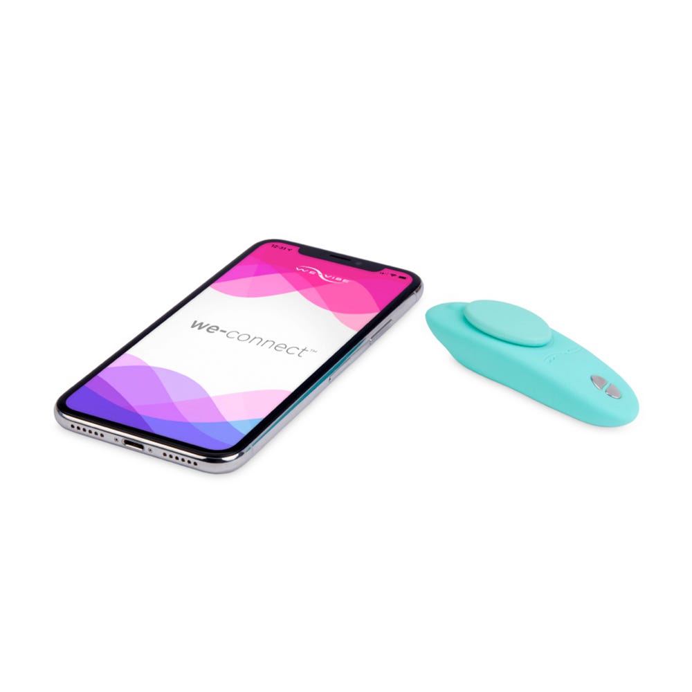 We-Vibe Moxie Trosvibrator och smartphone liggandes mot vit bakgrund.