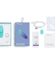 We-Vibe Moxie Trosvibrator och tillbehör mot vit bakgrund.