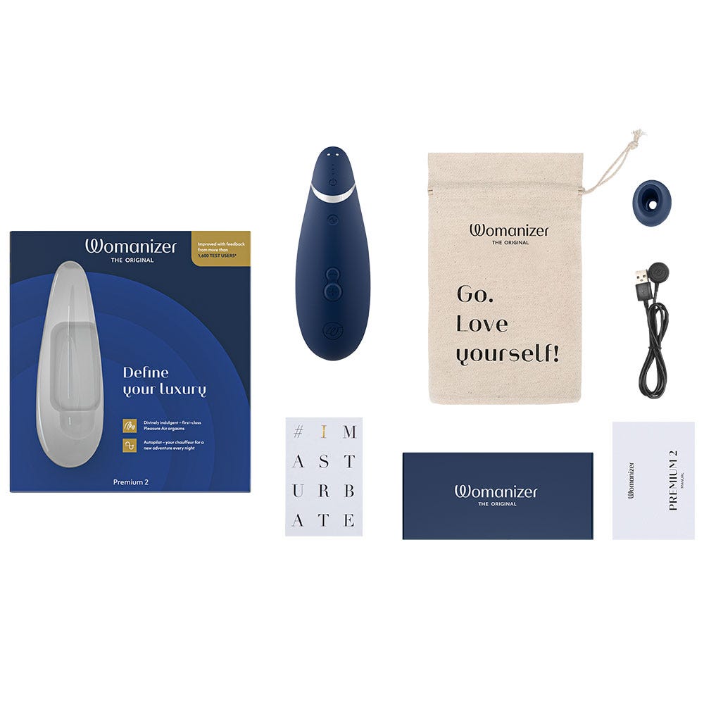 Womanizer Premium 2 Blueberry med tillbehör som laddare, blå låda och munstycke