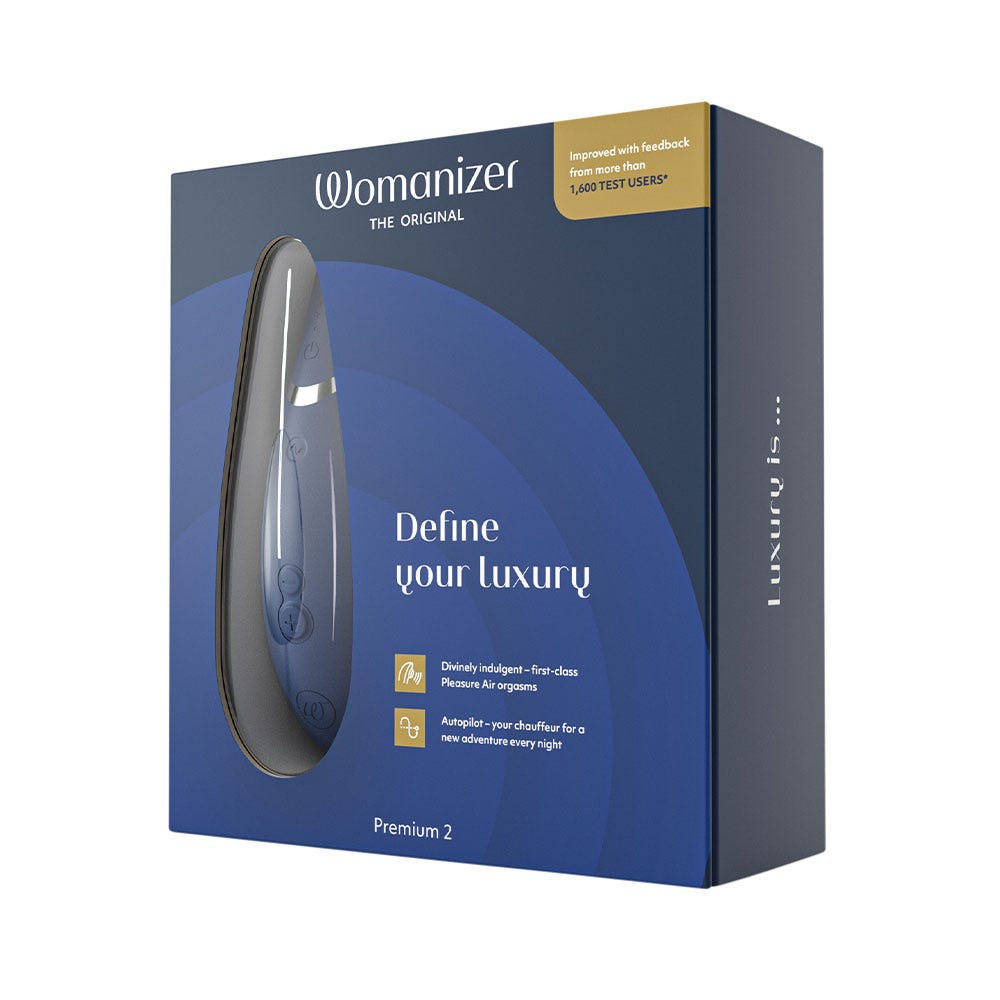 Womanizer Premium 2 Blueberry blå lufttrycksvibrator i en blå låda med gulddetaljer