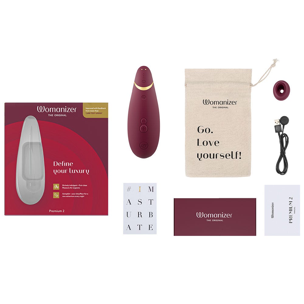 tillbehör till lufttrycksvibrator Womanizer Premium 2 Bordeaux. Påse för sexleksaker med texten &quot;Go. Love yourself&quot; och laddare.