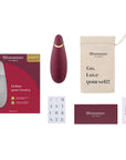 tillbehör till lufttrycksvibrator Womanizer Premium 2 Bordeaux. Påse för sexleksaker med texten "Go. Love yourself" och laddare.