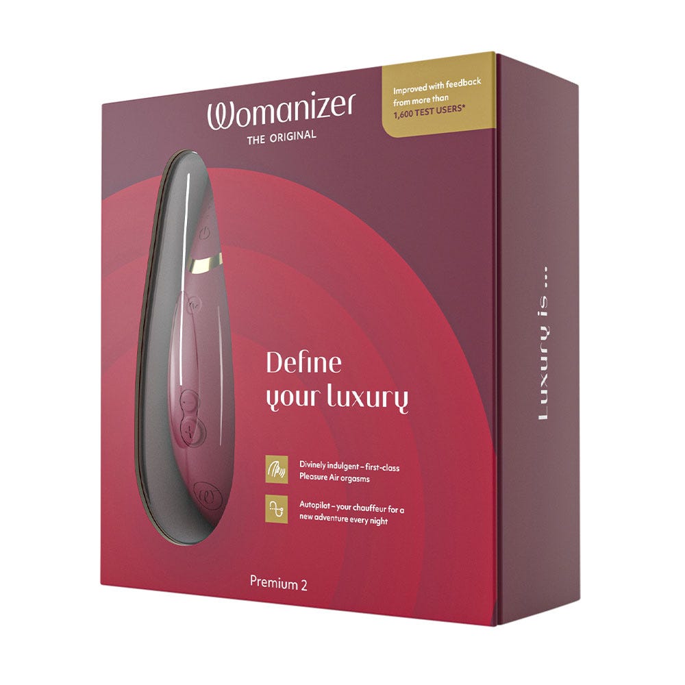 låda till Womanizer Premium 2 Bordeaux i vacker röd färg. Med texten &quot;Define Your luxury&quot;