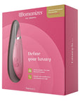 Womanizer Premium 2 Raspberry i en rosa låda som det står "Define Your luxury"