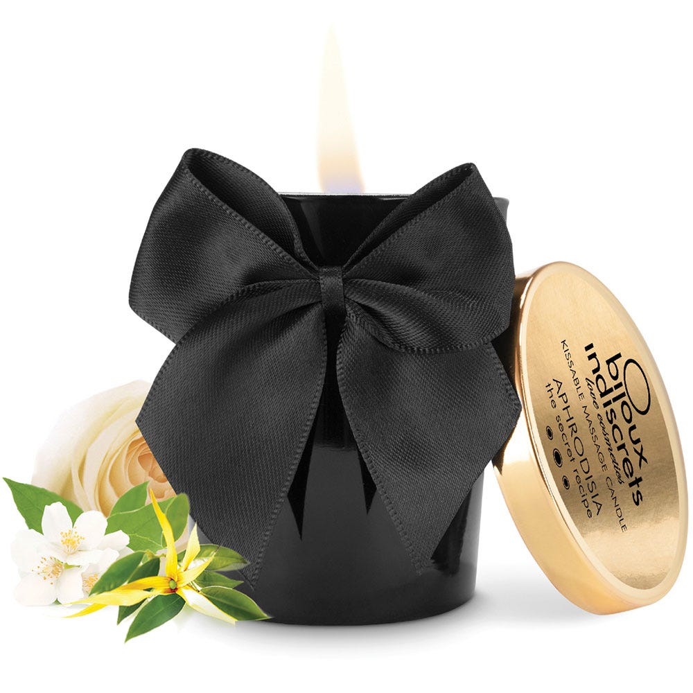 Aphrodisia Scented Massage Candle och vit ros mot vit bakgrund.