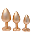 DreamToys Gleaming Love Gold Buttplug Set mot vit bakgrund. Köp analpluggar på Lustly.se