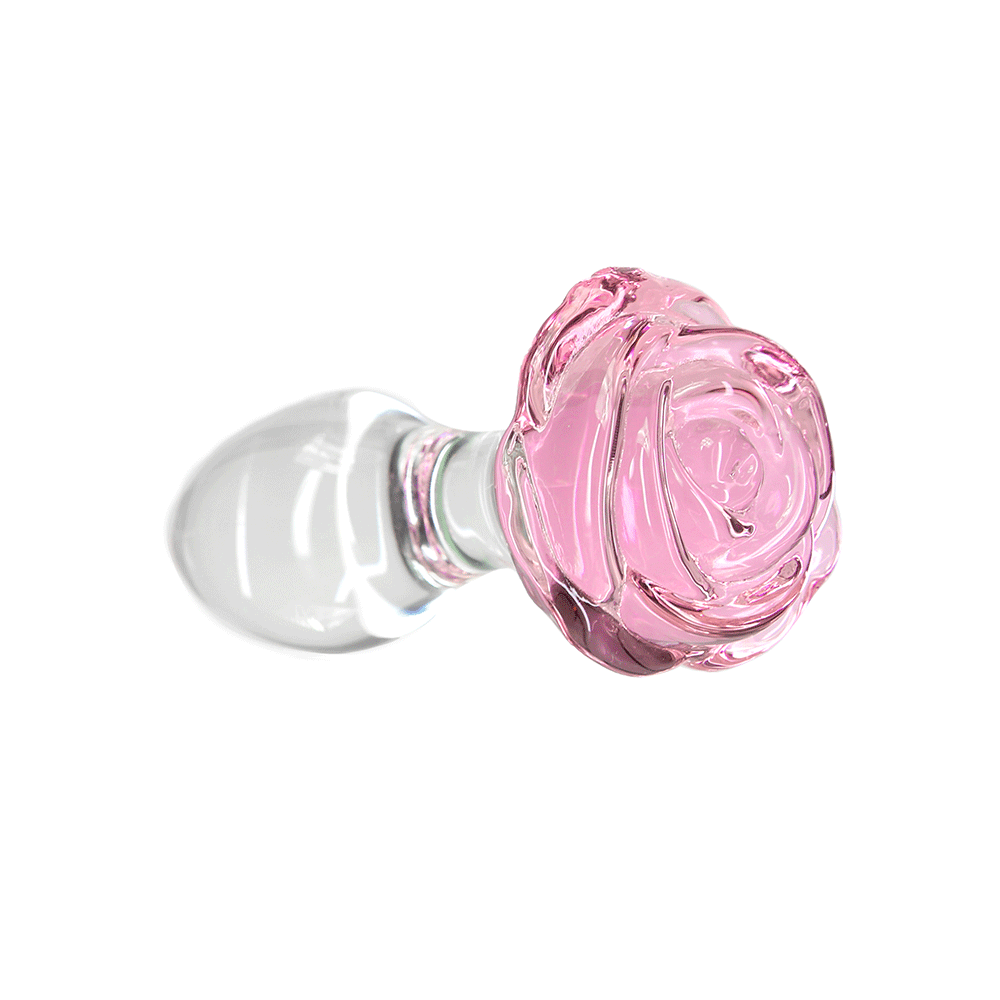 Pillow Talk Rosy Luxurious Glass Anal Plug with Bonus Bullet liggandes mot vit bakgrund.