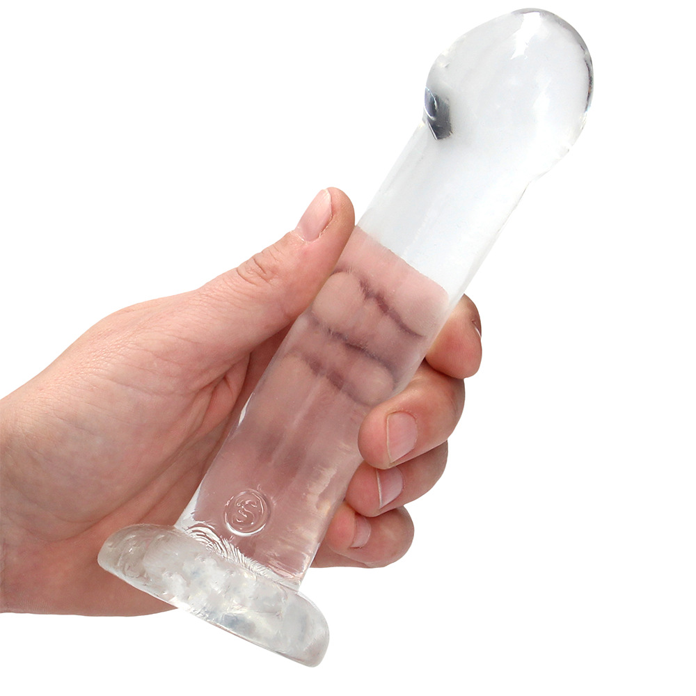 Hand som håller i Real Rock G-punktsdildo Transparent mot vit bakgrund.