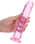 En hand med ljus hud och kortklippta naglar håller i RealRock Dildo with Suction Cup Pink 20cm mot vit bakgrund.