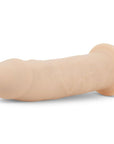 RF Deluxe Realistic Dildo Xavier liggandes mot vit bakgrund.