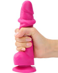 Hand som håller i Strap-On-Me Sliding Skin Realistic Dildo Fuchsia S mot vit bakgrund.