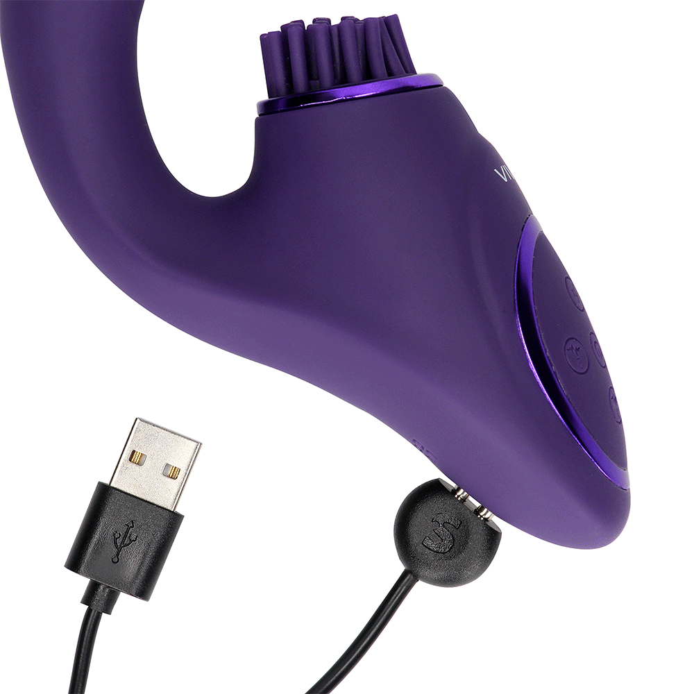 VIVE Gen Rabbitvibrator med Borste Lila med i kopplad USB-laddare mot vit bakgrund.