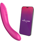 We-vibe Rave 2 Fuchsia bredvid en smartphone mot vit bakgrund.