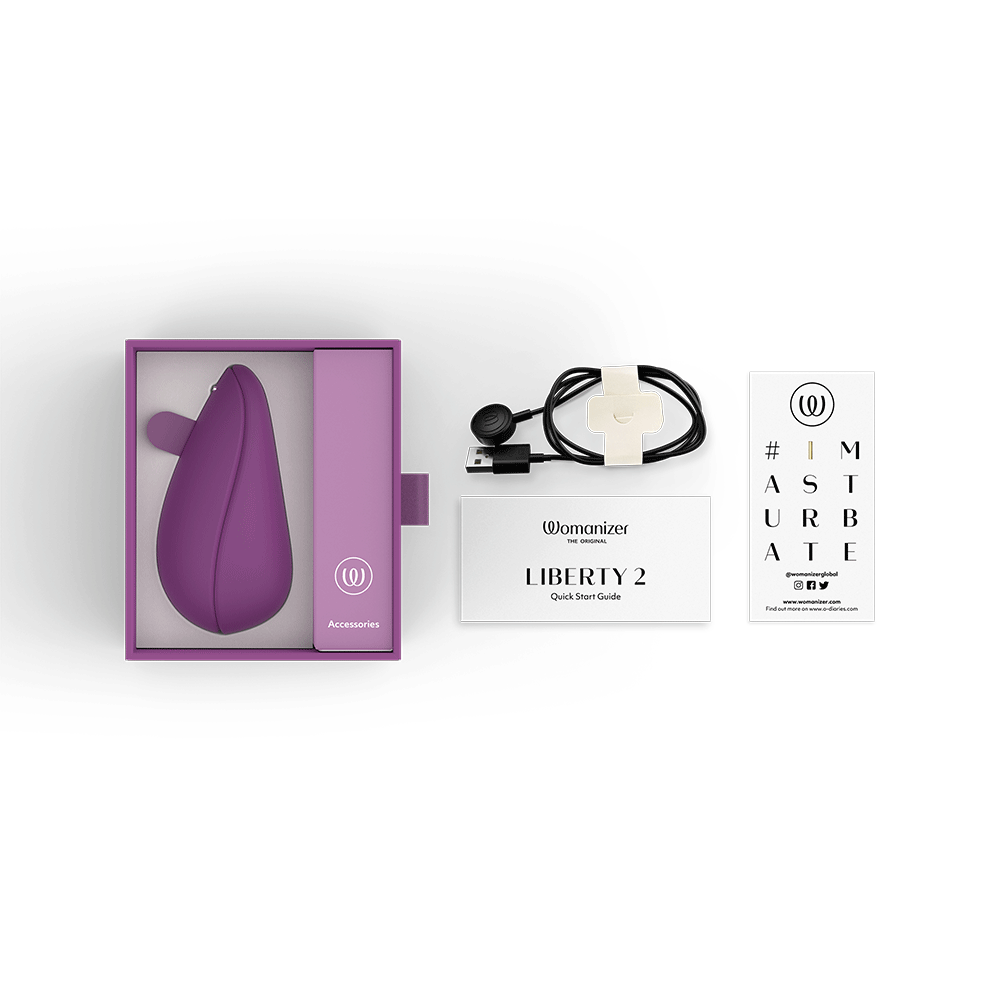 Womanizer Liberty 2 Purple och tillbehör mot vit bakgrund.