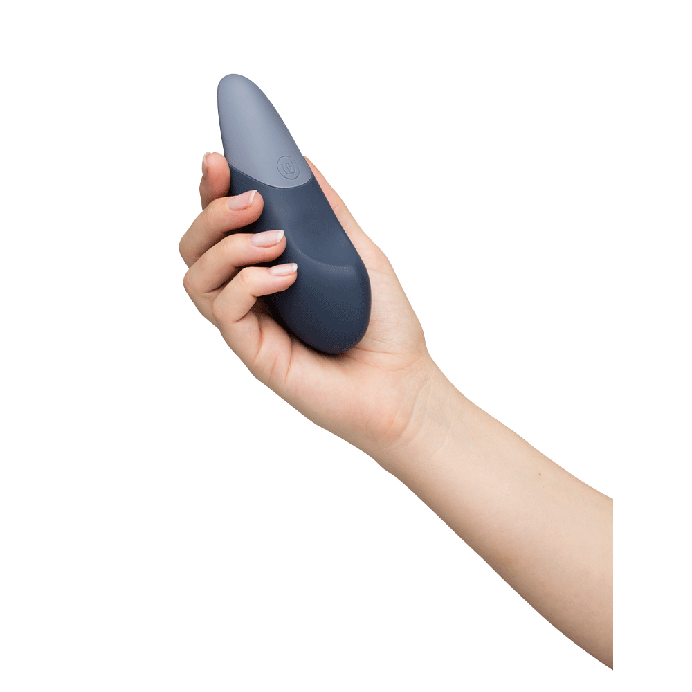 Hand som håller i Womanizer Vibe Dark Blue Klitorisvibrator, sidvy.